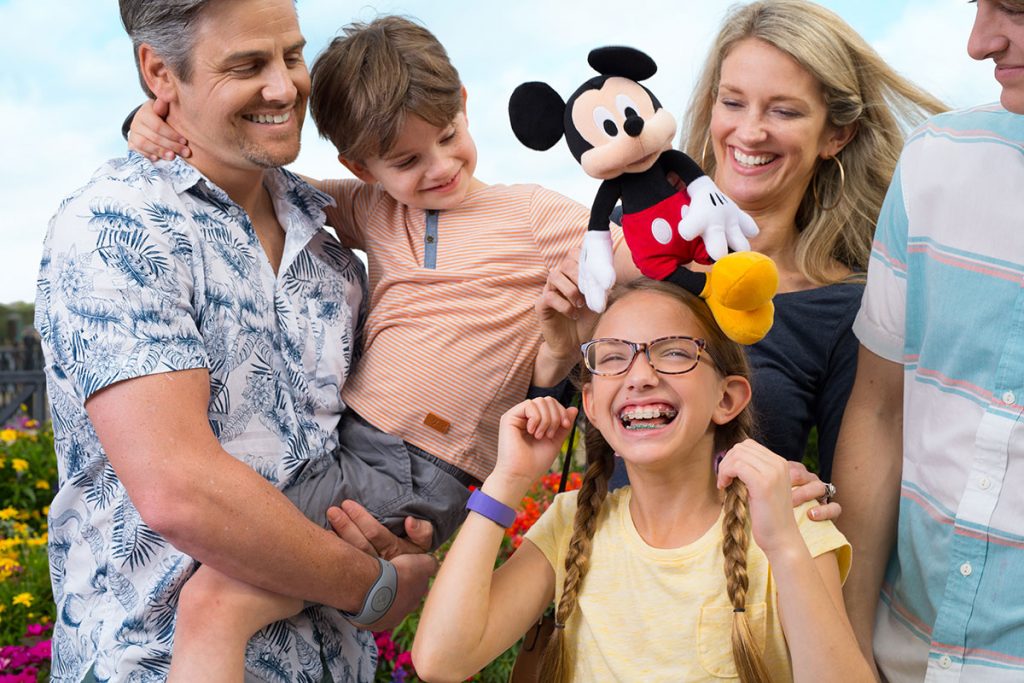 Happy family at Disney with Mickey plush